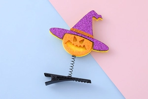 Detail of Halloween hair clip with purple glitter witch hat and orange felt pumpkin face