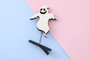 Detail of white glitter ghost hair clip with spring and duckbill clip on blue background
