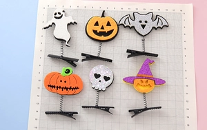 Detail of Halloween hair clips set with pumpkin, ghost, and bat on spring metal clips
