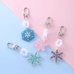 Sparkly glitter snowflake keychain set with colorful beads in four pastel colors