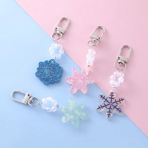 Sparkly snowflake keychains in blue, pink, green and purple with iridescent beads