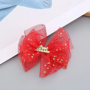 Close-up of red mesh Christmas bow with gold stars and Merry Christmas lettering