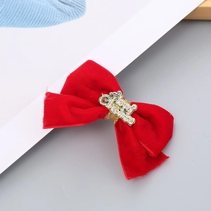 Detail of red velvet Christmas headband with golden Merry Christmas metallic lettering