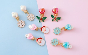 Close-up of assorted Christmas clip-on earrings with snowflake and holly berry designs