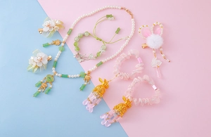 Macro shot of a Chinese Hanfu accessory set with pearl necklace and floral hairpins