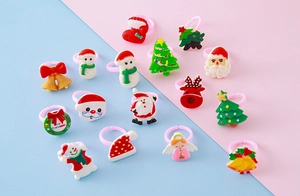 Macro shot of assorted Christmas resin rings with Santa, elk, and snowman designs