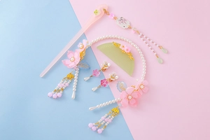 Detailed set of pink cherry blossom hairpins and earrings with elegant long tassels