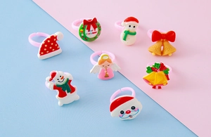 Macro shot of assorted Christmas resin rings with snowman and Santa Claus icons