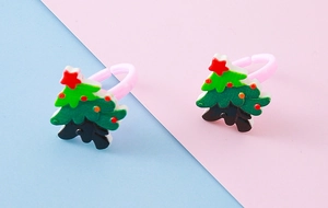 Close-up of resin Christmas tree rings for kids with adjustable pink bands and stars