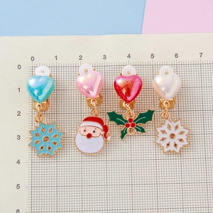 Children's Christmas clip-on earrings featuring snowflake, Santa, and holly pendants