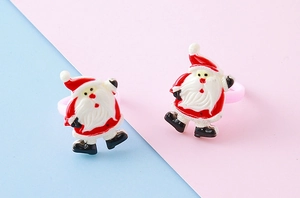 Detailed view of two resin Santa Claus rings featuring classic festive red and white colors