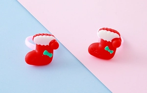 Close-up of red Christmas stocking rings with green bow detail for holiday gift