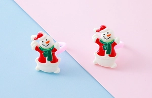 Close-up of resin Christmas snowman ring with red hat and green scarf for kids