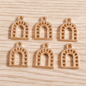 Golden horseshoe U-shaped arch pendants for DIY jewelry making on wooden background
