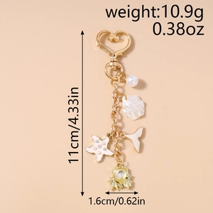 Detailed size view of gold sea shell keychain with pearl and starfish charms