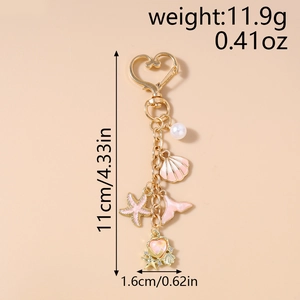 Detailed view of ocean theme keychain with pink starfish and shell charms in gold