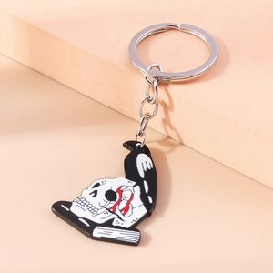 Detailed close-up of a skull and crow enamel keychain with zinc alloy metal ring