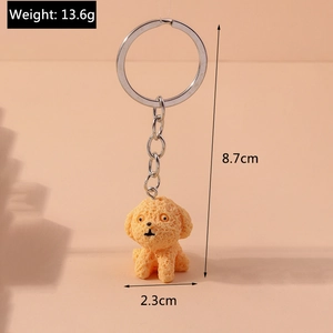 Close-up of curly orange teddy dog keychain with silver ring and detailed dimensions