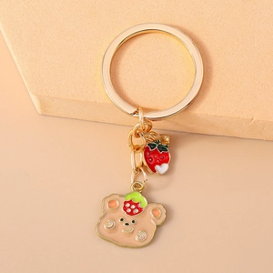 Cute strawberry bear keychain with golden ring and red charm for bag decoration