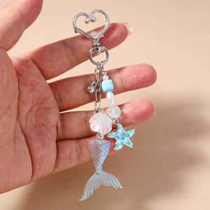 Détail du porte-clés queue de sirène avec étoile de mer, coquillages et perles bleues