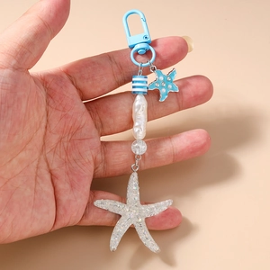 Detail of starfish keychain with blue striped beads and glitter sea star pendant