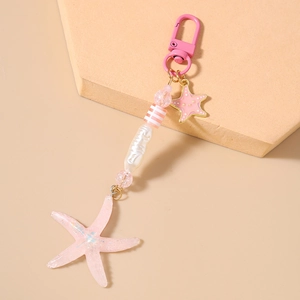 Detailed shot of pink starfish keychain with striped beads and enamel charms