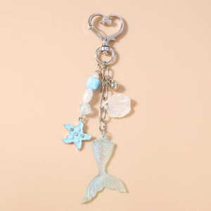 Détail d'un porte-clés thème océan avec étoile de mer bleue et pendentif queue de poisson