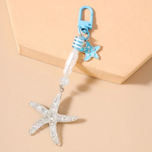 Detail of starfish keychain with blue striped beads and glitter sea star pendant