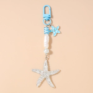 Detail of nautical keychain with striped beads and sparkling starfish on beige base