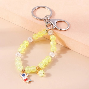 Astronaut beaded keychain with yellow crackle glass beads and a cute spaceman pendant