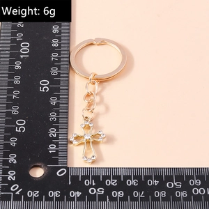 Detail of 6g gold rhinestone cross keychain accessory with ruler measurement