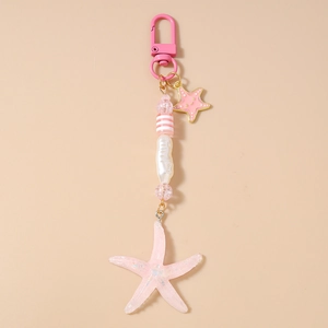 Detailed shot of pink striped beads and starfish pendant keychain with golden star charm