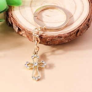 Luxury gold hollow cross keychain with sparkling rhinestones on decorative wood block