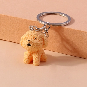 Detailed macro view of orange-pink poodle keychain with textured surface and silver ring