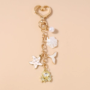 Detailed view of ocean-themed keychain with pearl shells, starfish, and heart pendant
