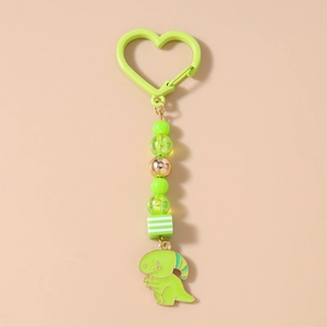 Détail du porte-clés dinosaure vert avec mousqueton en cœur et perles colorées
