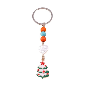 Detail of Christmas tree keychain with colorful beads and heart resin charm on white background