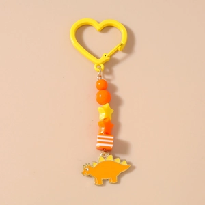 Détail du porte-clés dinosaure perlé avec pendentif stégosaure orange et fermoir coeur