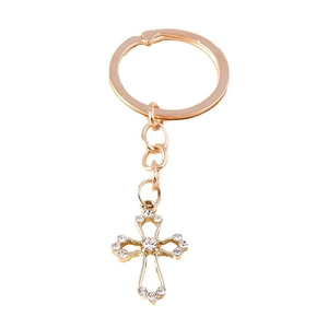 Rose gold hollow cross keychain with sparkling white rhinestones on white background