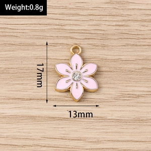 Detailed macro view showing the 17mm pink enamel flower charm with a center rhinestone