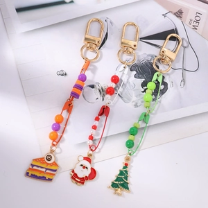 Colorful beaded safety pin keychains featuring Christmas tree and pizza enamel charms