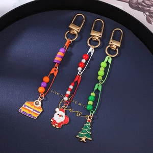 Three creative handmade keychains with eye-cake, Santa, and Christmas tree charms