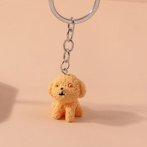 Detailed view of an orange puppy keychain with textured surface and silver keyring