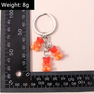 Detail shot of orange gradient gummy bear keychain with silver ring weighing 8g