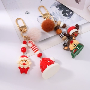 Detail of Christmas keychains with Santa Claus, plush balls, and reindeer charms