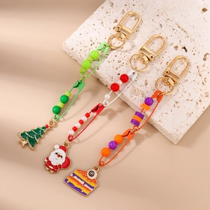 Detailed view of Christmas tree and Santa pendants with colorful beads and lobster clasps