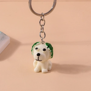 Detail view of the funny cartoon dog keychain with green cabbage leaf on top of head