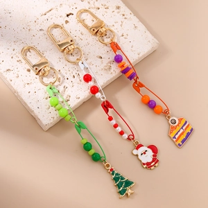 Christmas keychain set with Santa, tree, and colorful beads on gold-tone safety pins
