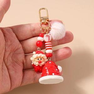 Detail of Christmas keychain with plush ball and cute Santa Claus soft rubber pendant