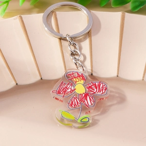 Fashionable doodle flower keychain with transparent acrylic pendant on a ceramic tray